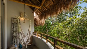 A hammock on a balcony with a view of lush greenery. - El Cielo 1BRM Penthouse private roof sleeps 3 (Tulum)