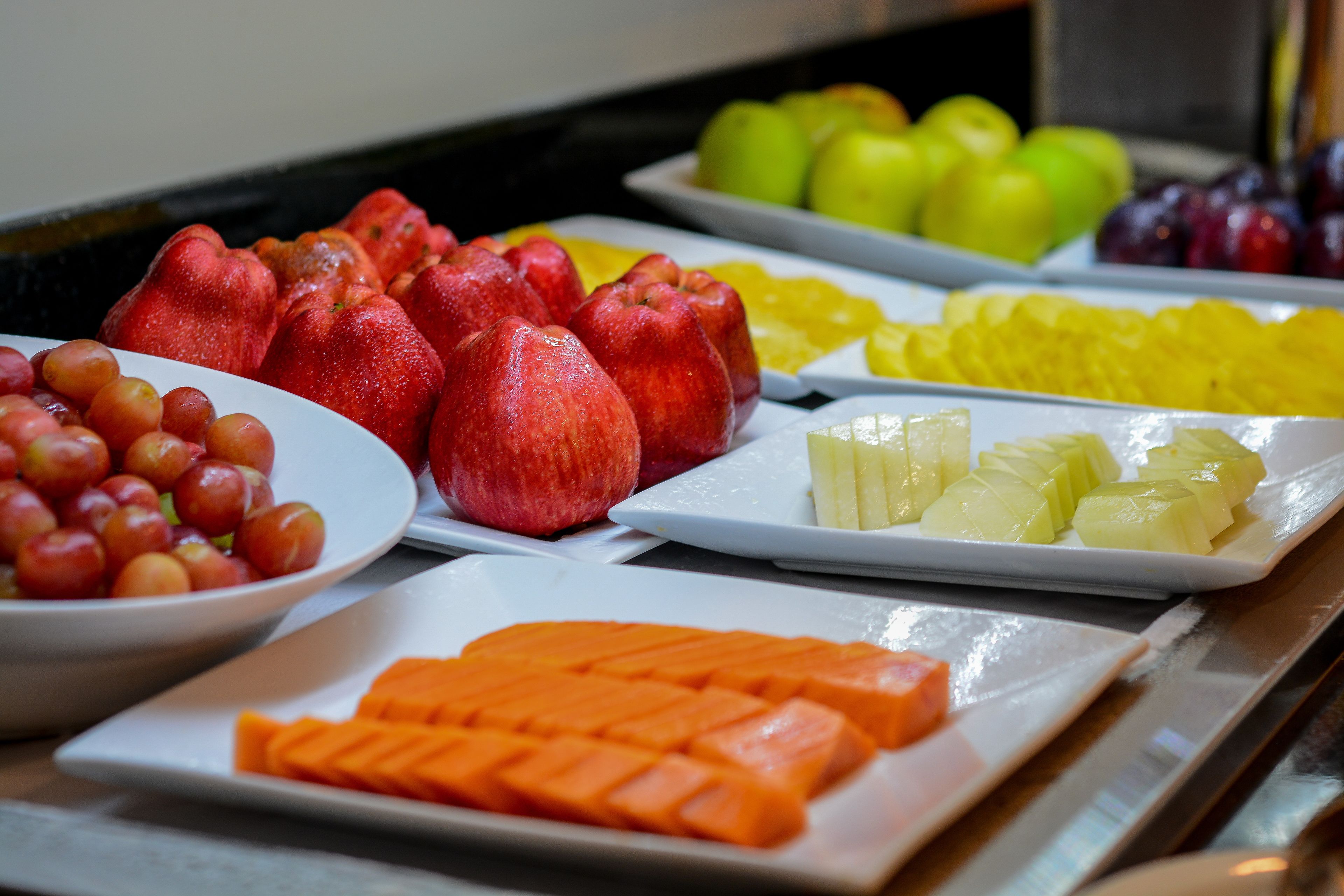 A buffet with various fruits and vegetables.