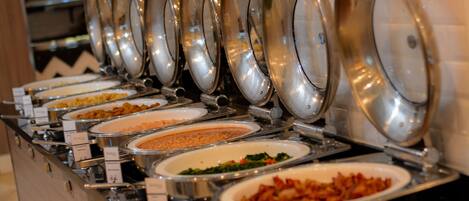 A buffet with multiple serving dishes, each with a lid.