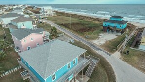 A coastal residential area with houses, a beach, and a road. - Once Upon A Tide 3 Bedroom Home by RedAwning (Port Bolivar)