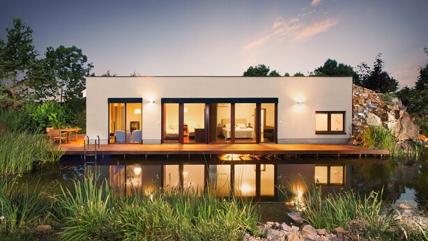 A modern house with a pool, wooden deck, and a stone wall. - Luxury holiday home (Rosice)