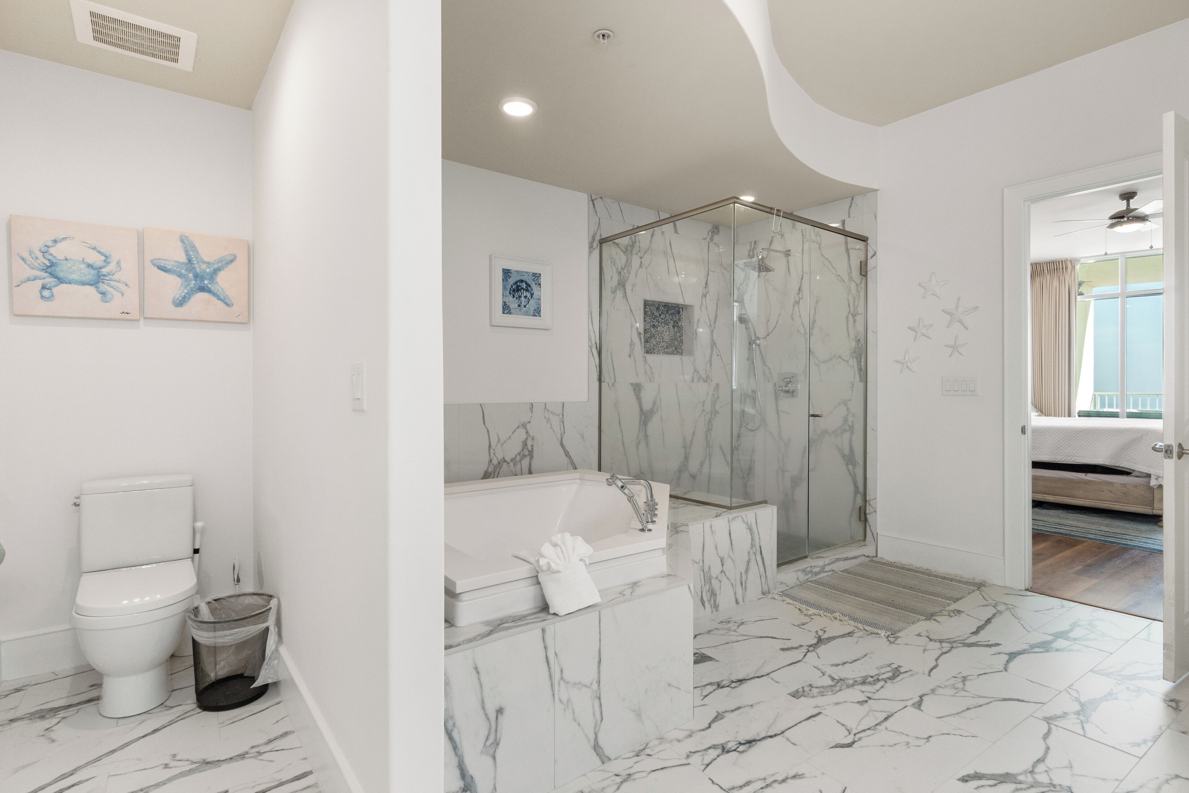 A bathroom with a toilet, bidet, shower, and bathtub.