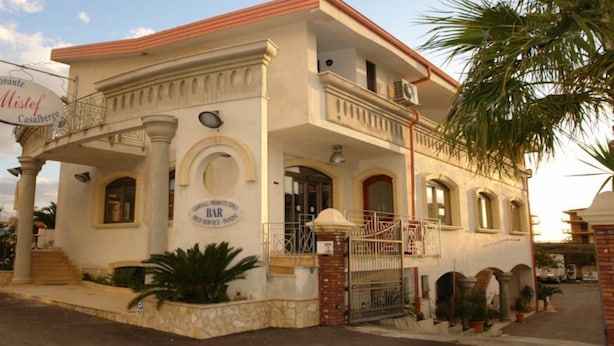A two-story building with a sign for "Ristorante Mistef Casalbergo" and a "BAR" sign. - Hotel Mistef (Falerna)