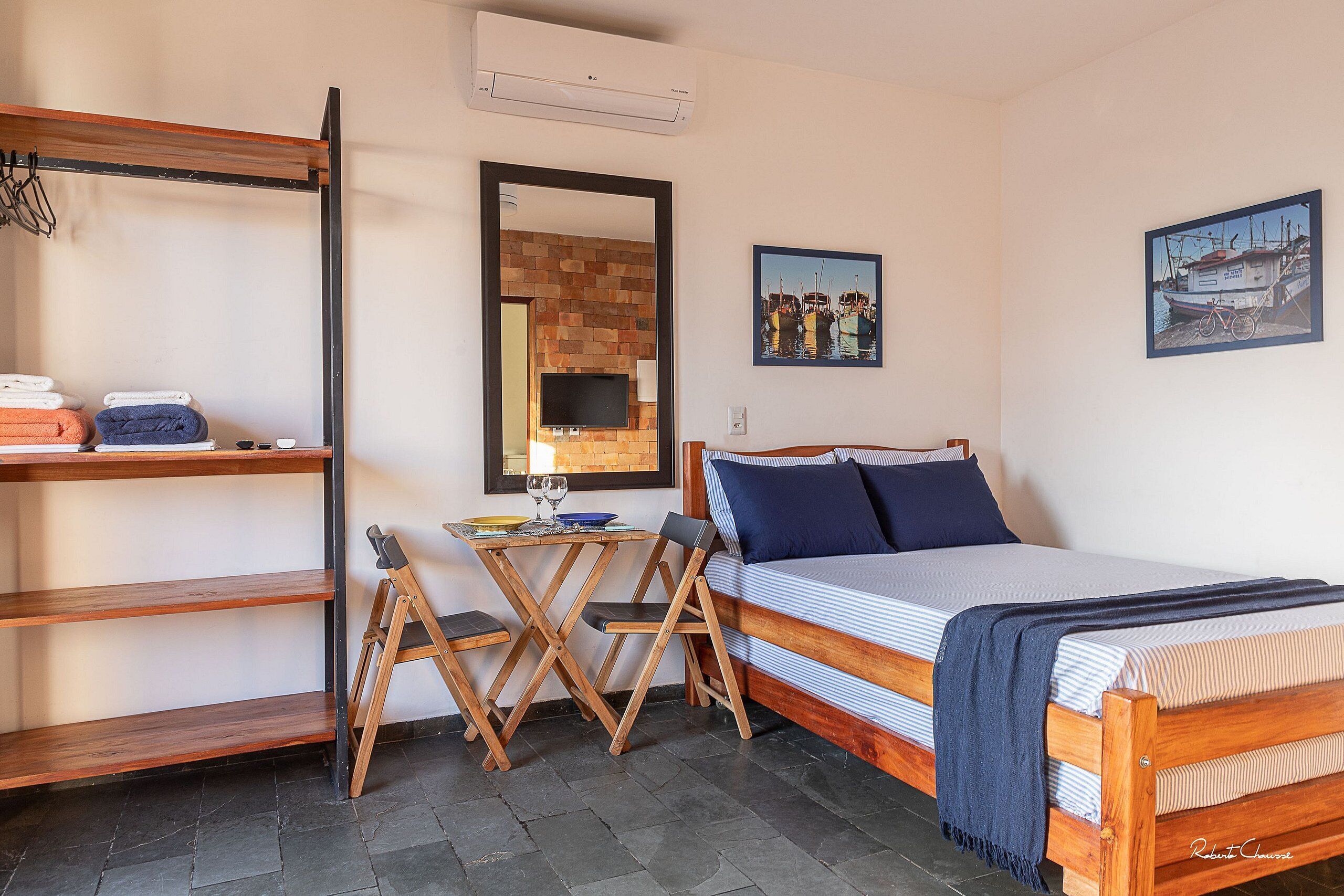 A bedroom with a bed, a desk, and a chair.