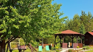 A rustic outdoor area with a wooden gazebo, a small bridge, and a picnic table. - House Zdravko (Plitvicka Jezera)