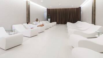 Relax in a serene space with cushioned lounge chairs and a tranquil ambiance.