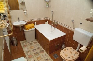 Bathtub, hair dryer, towels, soap