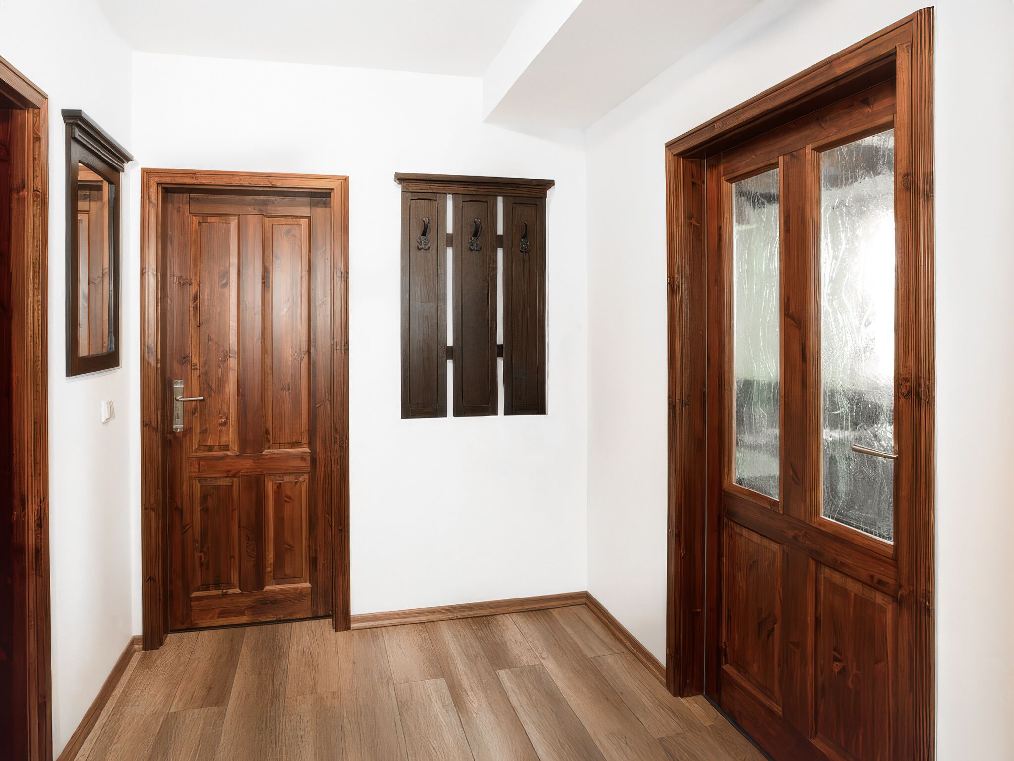 Un corridoio con porte in legno e una finestra.