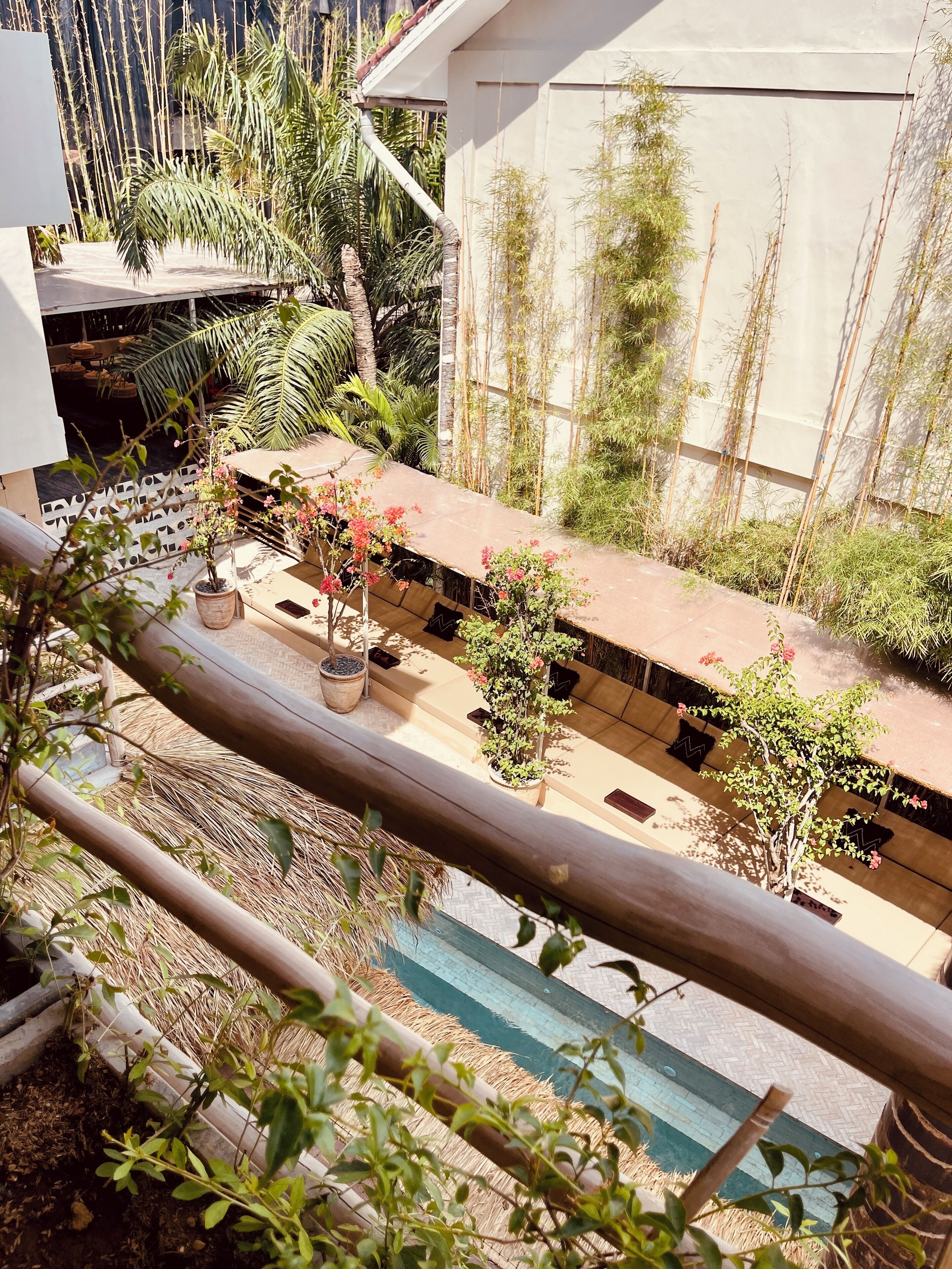 A rooftop garden with potted plants and a seating area.