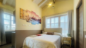 A bedroom with a large bed, a nightstand, a wall-mounted painting, and a window with curtains. - Exclusive Tuscan Villa with Black Pool & Jacuzzi (Altopascio)