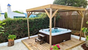 A hot tub under a wooden pergola on a wooden deck with potted plants. - Algarvian House - Arroteia "Carpenter Houses" (Tavira)
