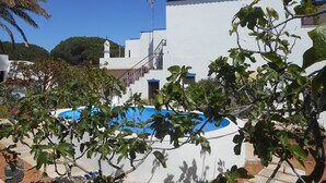 A white building with a blue-tiled roof, a swimming pool, and a staircase leading to an upper level. - Algarvian House - Arroteia "Carpenter Houses" (Tavira)