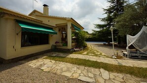 A house with a stone pathway leading to a covered patio area.