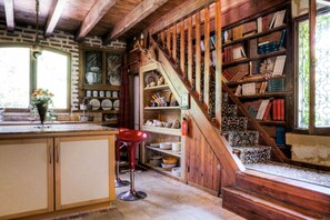 Step up to a cozy loft area with a book-filled nook and a window seat for taking in the view.