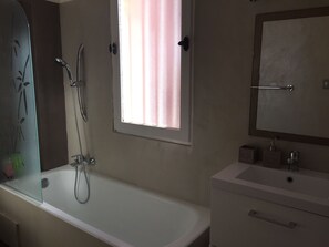 Bathtub, hair dryer, towels, soap