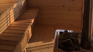 Eine Holzhütte mit einer Bank und einer Sauna.