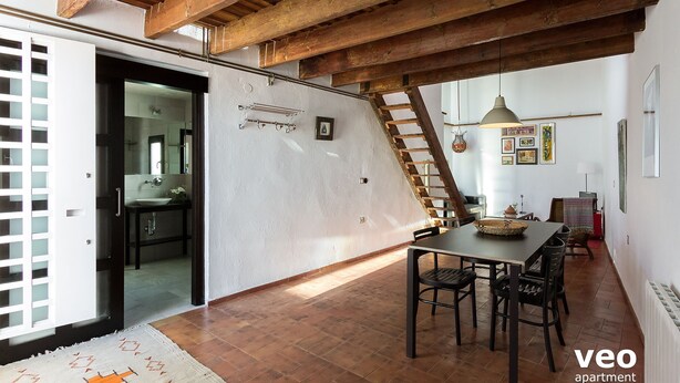 A spacious living area with a dining table, chairs, and a staircase leading to an upper level. - Ibarra Terrace. Top-floor duplex with Cathedral views, Santa Cruz (Sevilla)