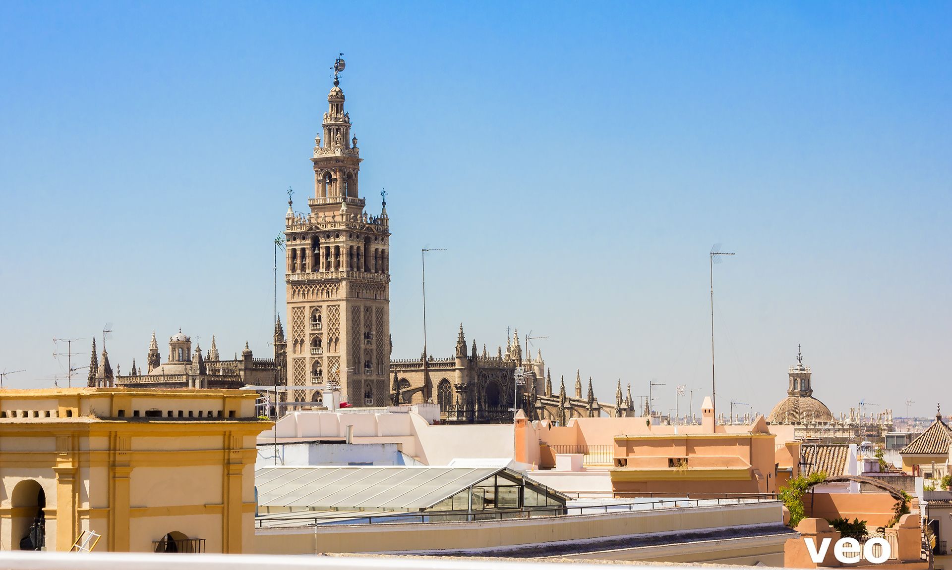 A view of a historic building with a tall tower and intricate architecture.