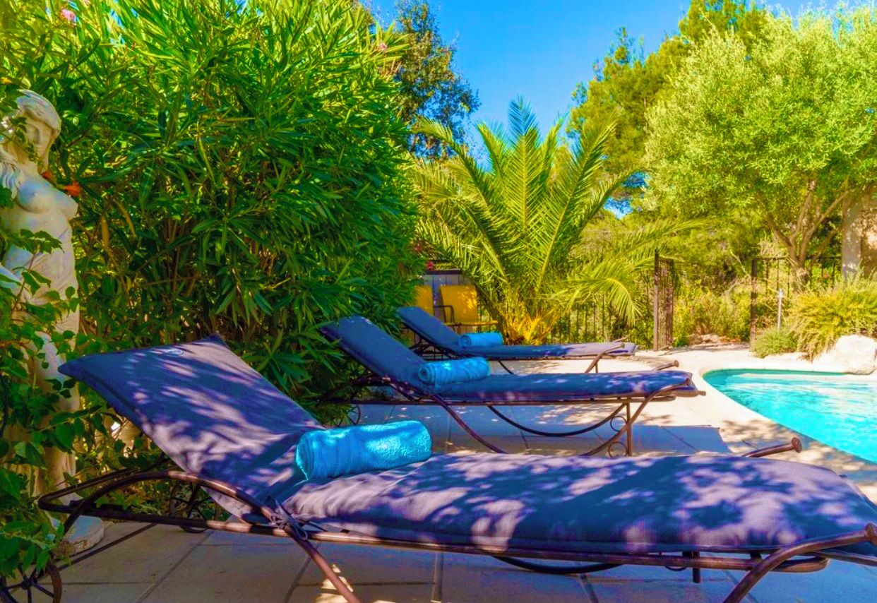 A poolside area with lounge chairs and a small pool.