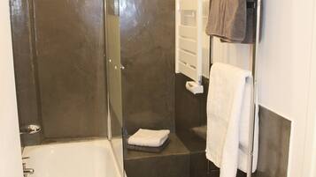 Bathtub, hair dryer, towels, soap