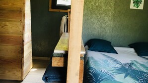 A wooden room with a bed, a bench, and a window. - LITTLE QUIET CORNER FOR NATURE LOVERS ... (Olivese)
