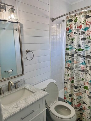Bathtub, hair dryer, towels, soap