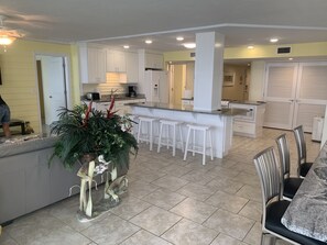 Enjoy cooking and dining in this well-lit kitchen with a central island and bar stools.