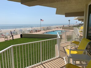 Enjoy the ocean view from this beachfront balcony, featuring a pool and access to the beach.