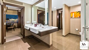 A modern bathroom with dual sinks, a large mirror, and a glass shower enclosure.