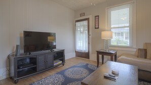 A living room with a flat-screen TV, a coffee table, a sofa, and a patterned rug. -  8 Min. to VT,  15 min. to RU & 4 min. to AQUATIC CENTER  (Christiansburg)