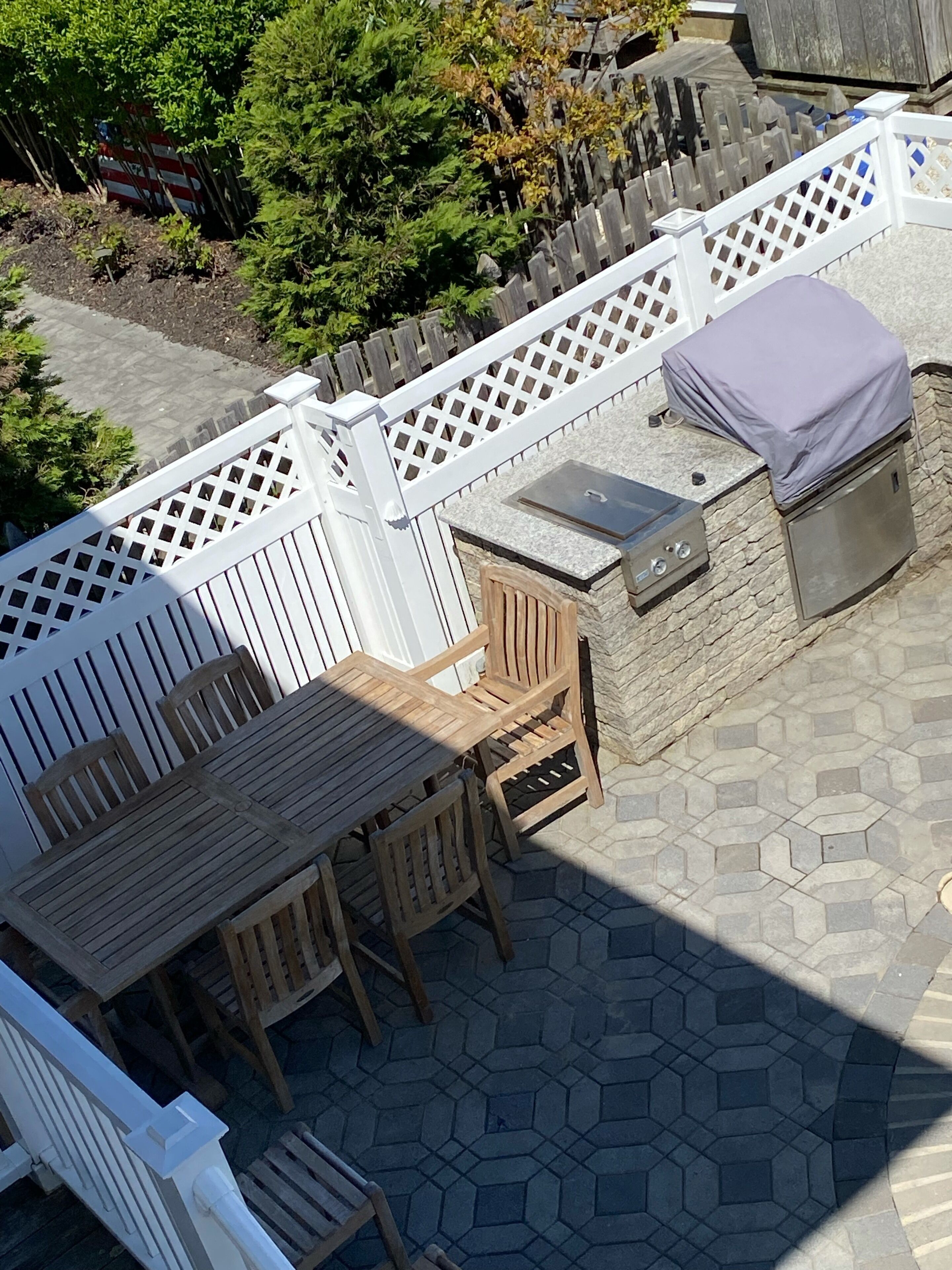 Outside dining area. Located in the pool enclosure next to the grill area. 