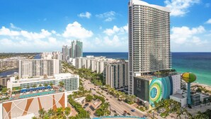 A high-rise hotel with a view of the ocean, a pool area, and a colorful mural. - LYFE RESORT,  OCEANFRONT BDG.  ROOFTOP POOL & RESTAURANT, WATER VIEWS GUARANTEED (Hollywood)