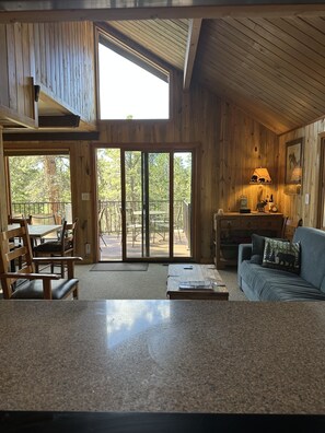 Relax in a spacious room with a sofa, coffee table, and patio access.