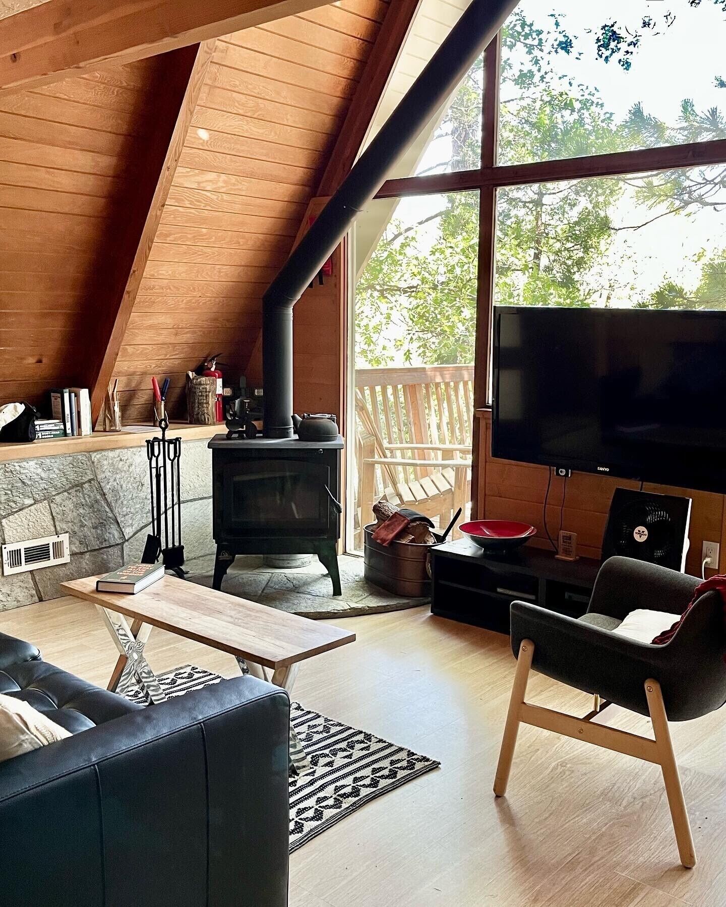 A cozy living room with a fireplace, a television, and a comfortable seating area.