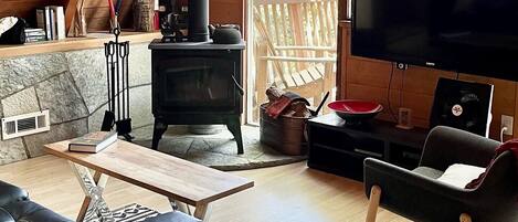 A cozy living room with a fireplace, a television, and a comfortable seating area.