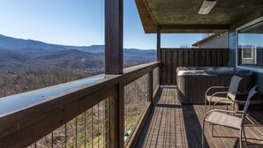 A balcony with a wooden railing, a hot tub, and a view of mountains. - Unreal Views GSMNP/Near DwTn Gatlinburg/Hot Tub (Gatlinburg)