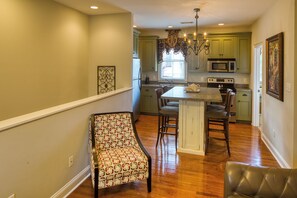 Living Room & Kitchen. Kitchen has all stainless steel appliances & plenty of cooking utensils for quick meals.
The white wall on left of photo looks over the stair case that leads up to the Carriage House on 2nd Floor over garage.