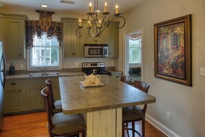 Fully outfitted kitchen with all stainless appliances & seating for 4.