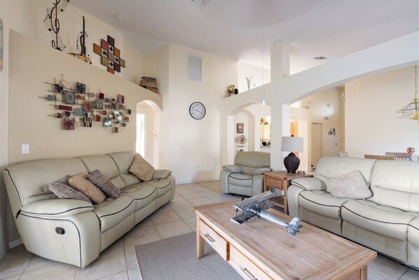 A spacious living room with two sofas, a coffee table, and wall art.
