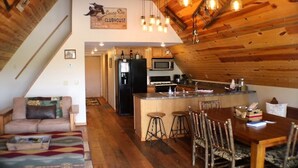 A cozy, rustic interior with a kitchen, dining area, and living space. - Cozy A-Frame house in heart of the midwest!!! (Quincy)