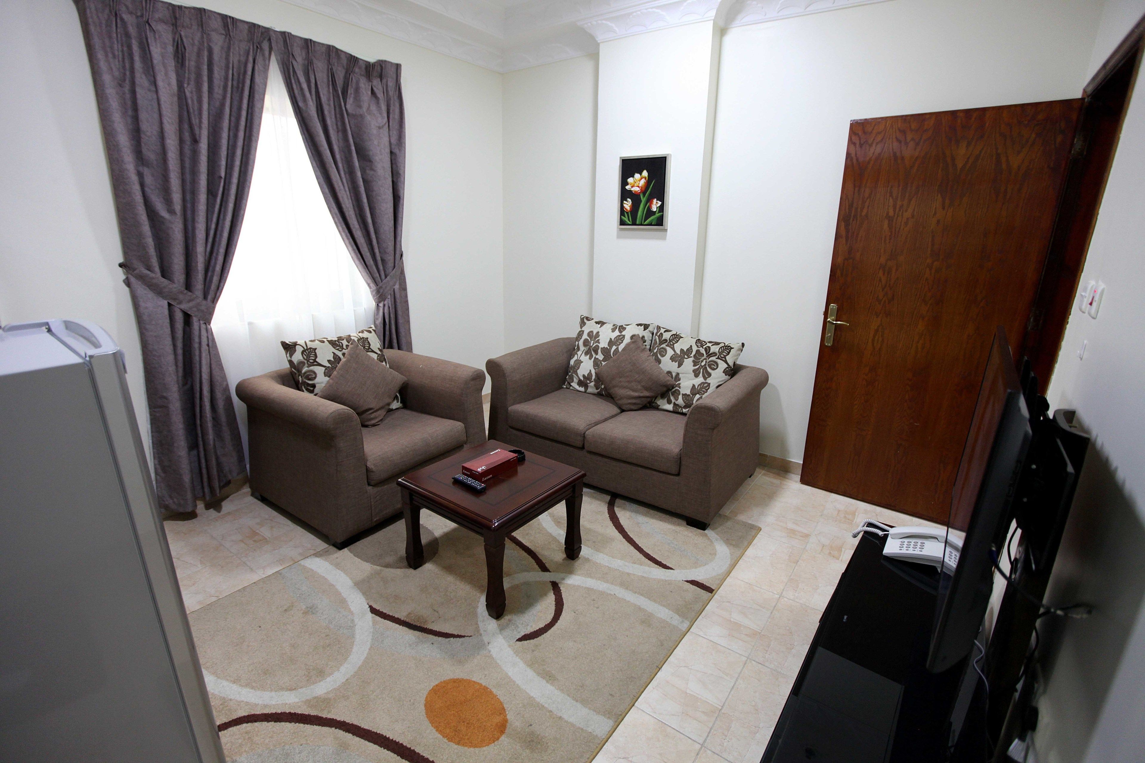 A living room with two sofas, a coffee table, and a TV.