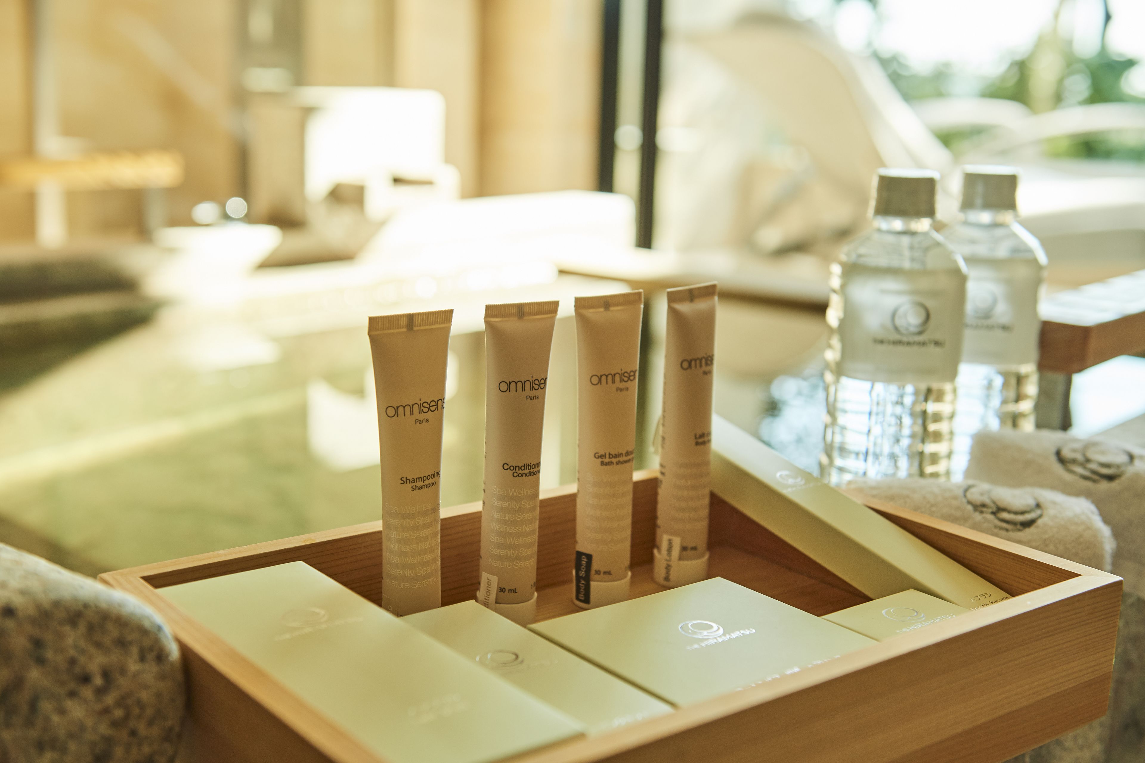 designer toiletries, hair dryer, bathrobes, slippers