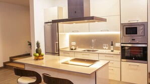 A modern kitchen with a central island, stainless steel appliances, and a sleek design.