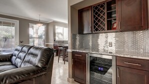 A modern kitchen with dark wooden cabinets, a stainless steel oven, and a tiled backsplash. - Resort Style 3 Bed, 3 Baths, Private Pool - Family Friendly -  Special CAD rate (Glendale)
