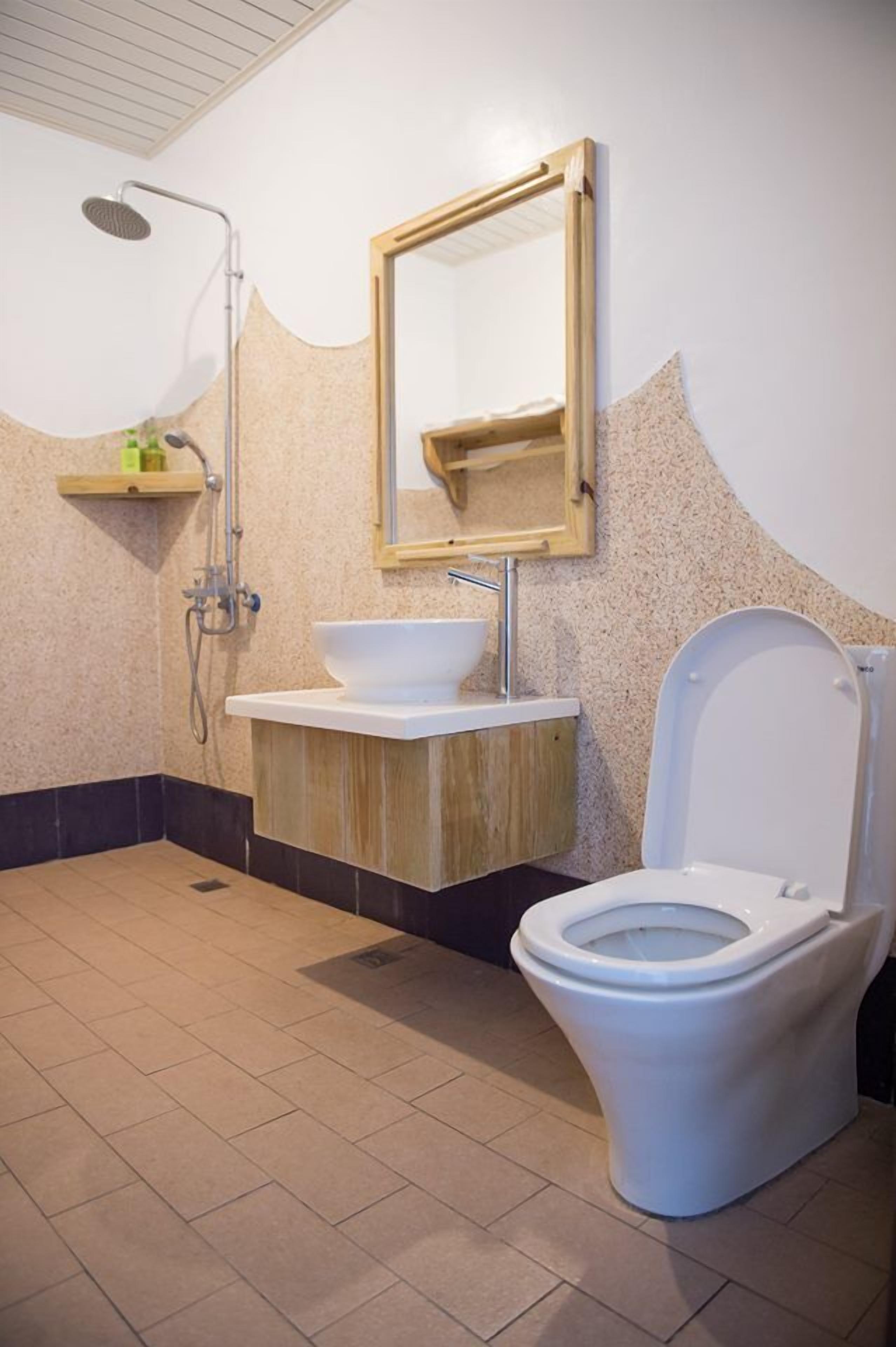 A bathroom with a shower, sink, and toilet.