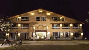A two-story building with a central entrance, large windows, and a well-lit facade. - Mangyi Inn (Hengchun)