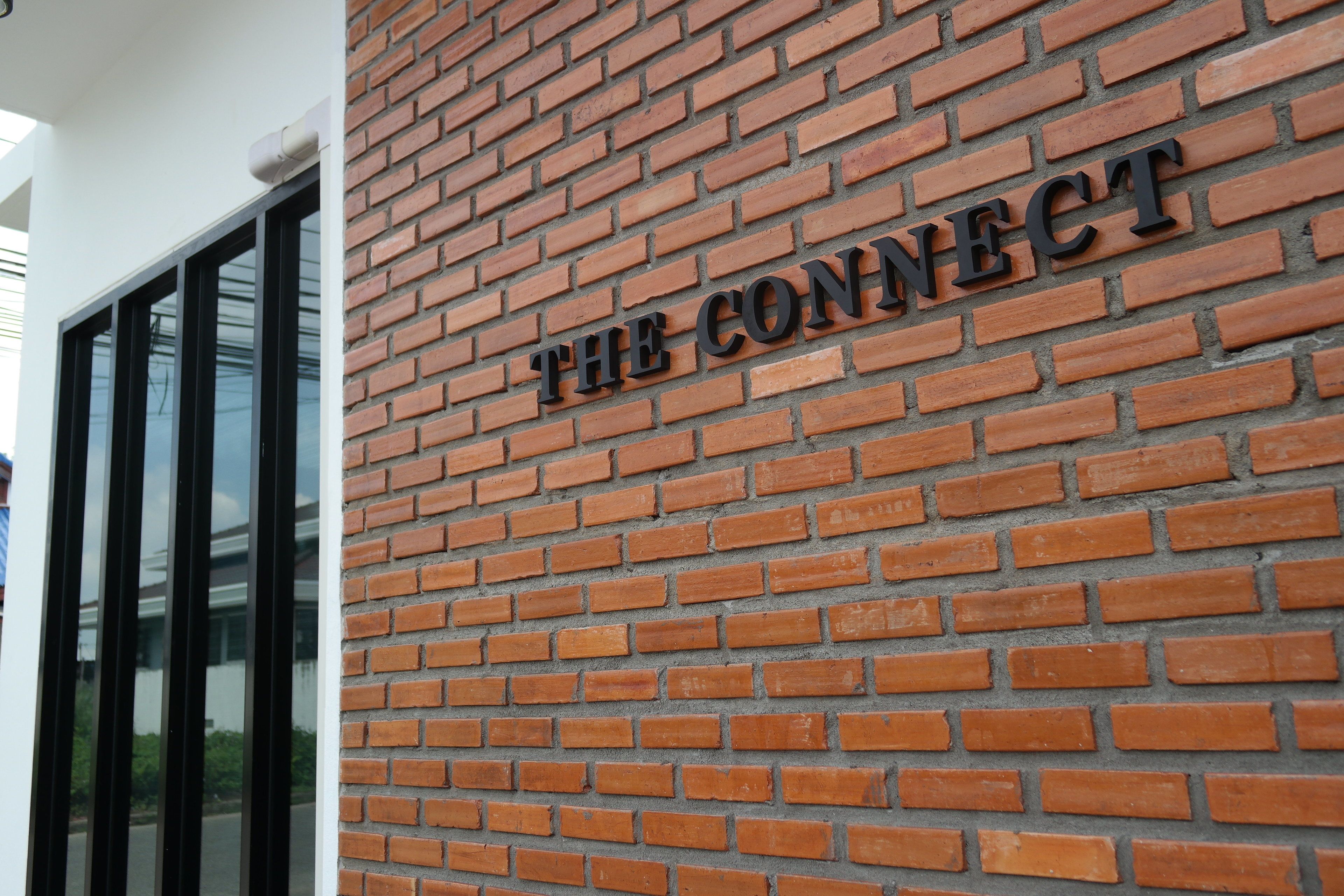 A brick wall with the words "THE CONNECT" in metal letters.