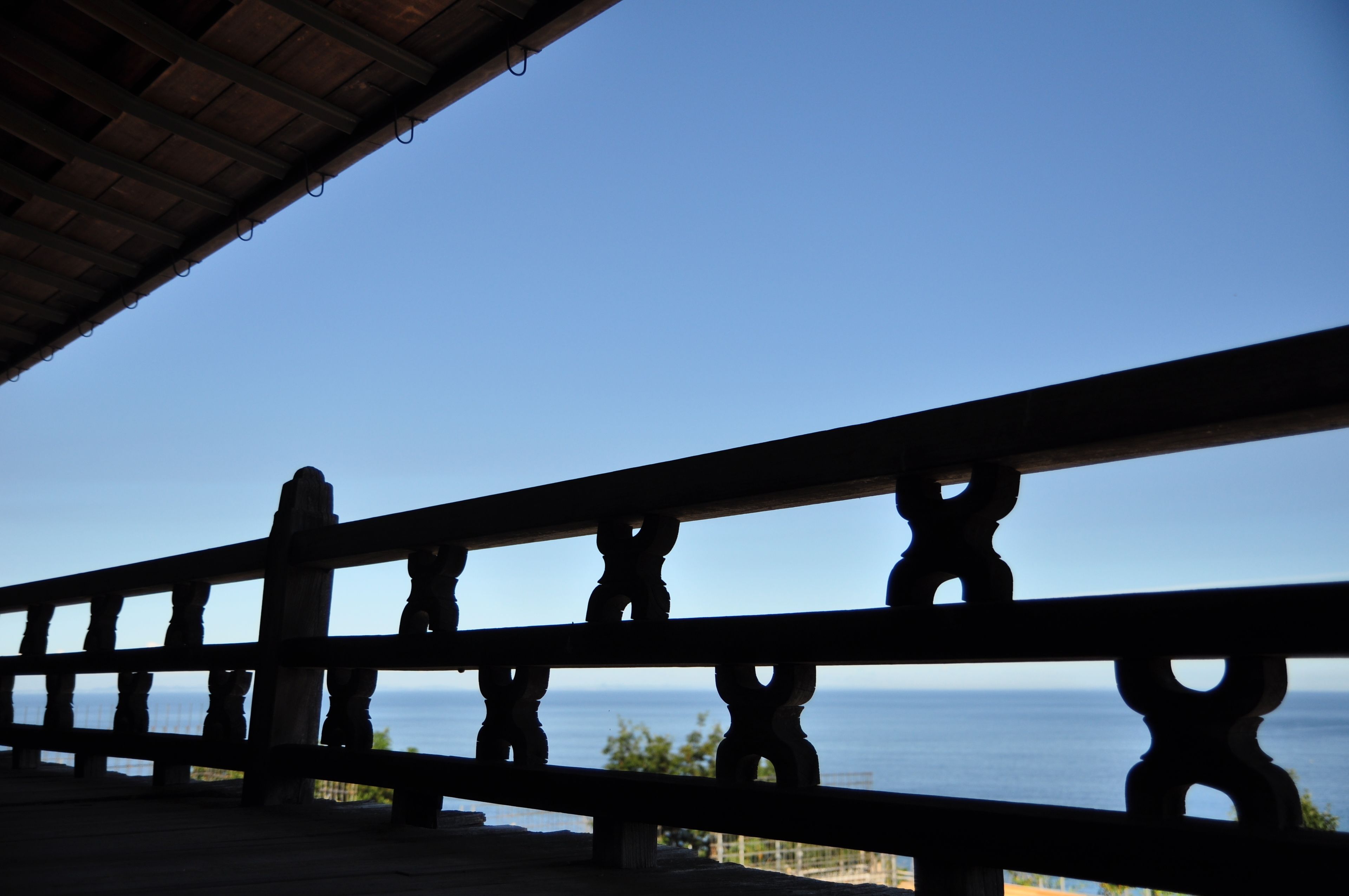 A balcony with a view of the ocean.