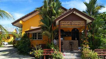Welcome to our information center, surrounded by lush greenery and palm trees.