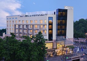 A modern hotel with a prominent 'FORTUNE' sign, multiple floors, and a checkered outdoor area.